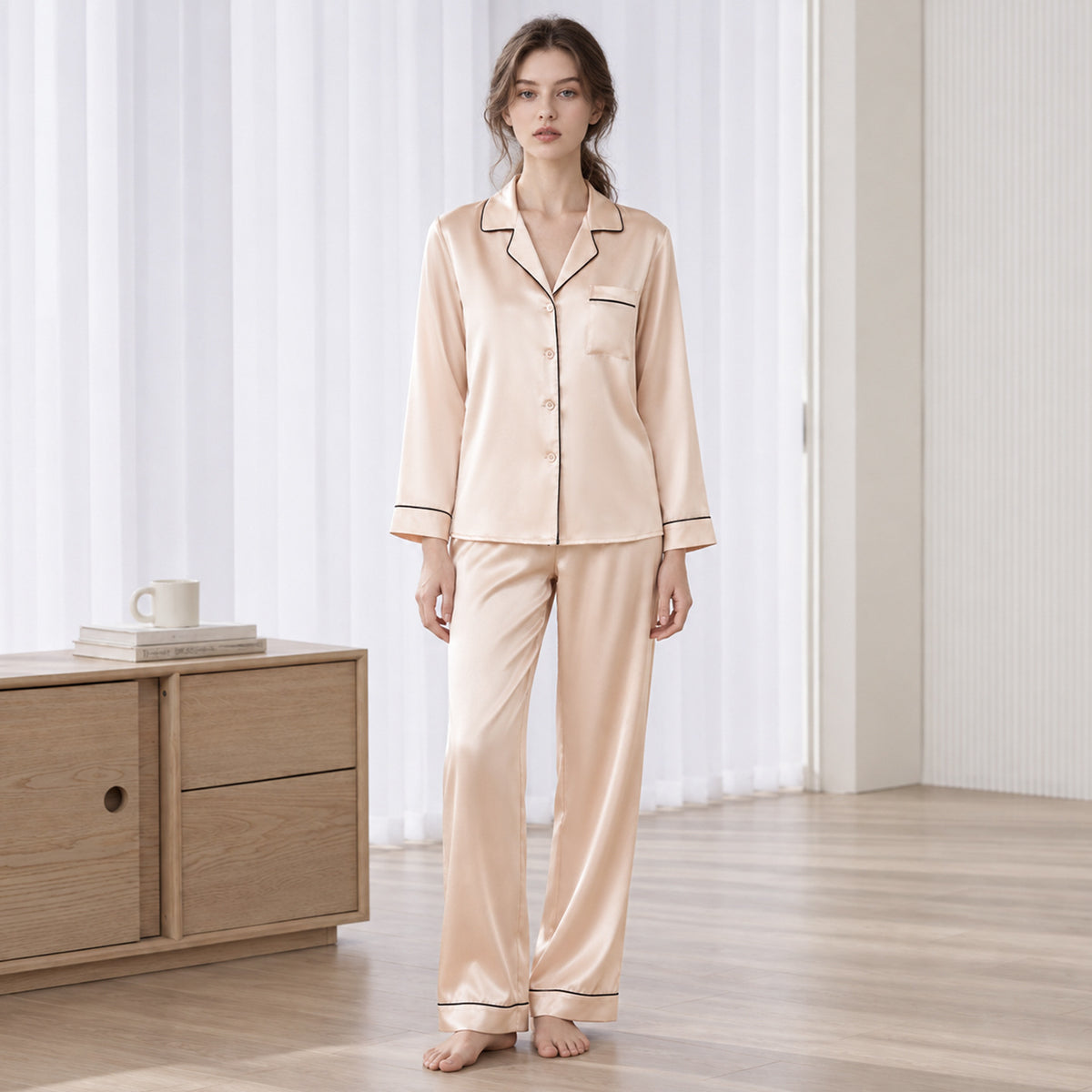 Light apricot silk pajama set with long-sleeve button-up top and matching long pants, trim