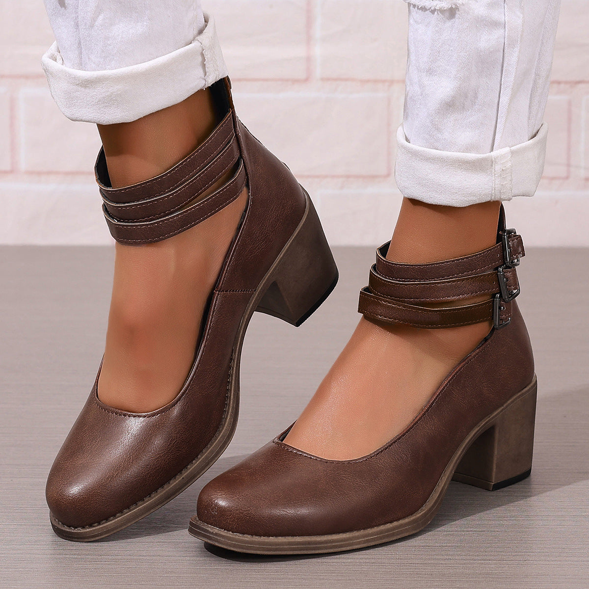 Brown ankle boots with mid-height heel and buckle ankle strap