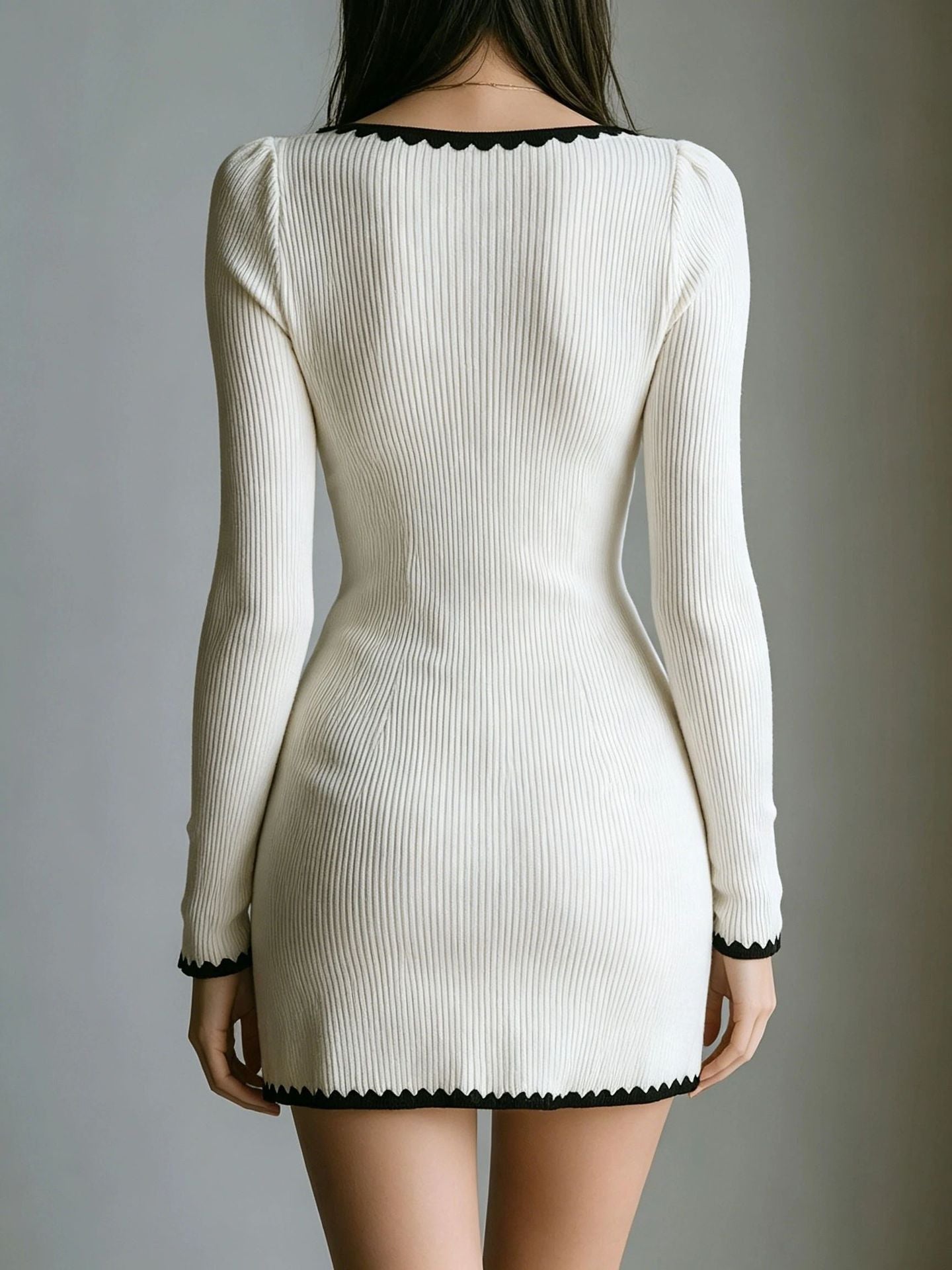 White ribbed knit mini dress with long sleeves and scalloped neckline and hem, back view