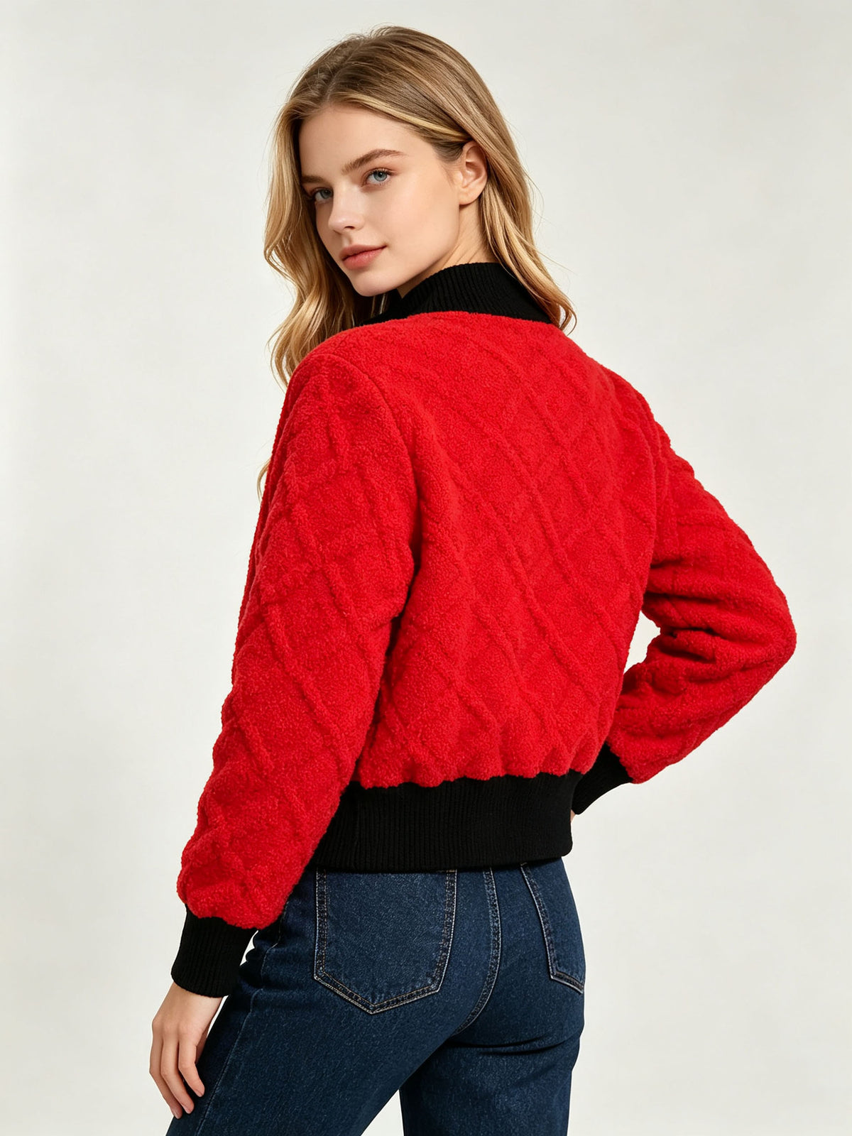 Red cable-knit cardigan, back view with black ribbed hem and stand collar.