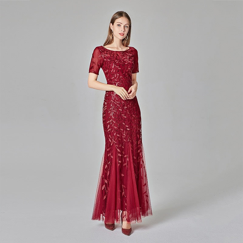 Wine red sequin mesh mermaid evening gown with short sleeves and flared hem.