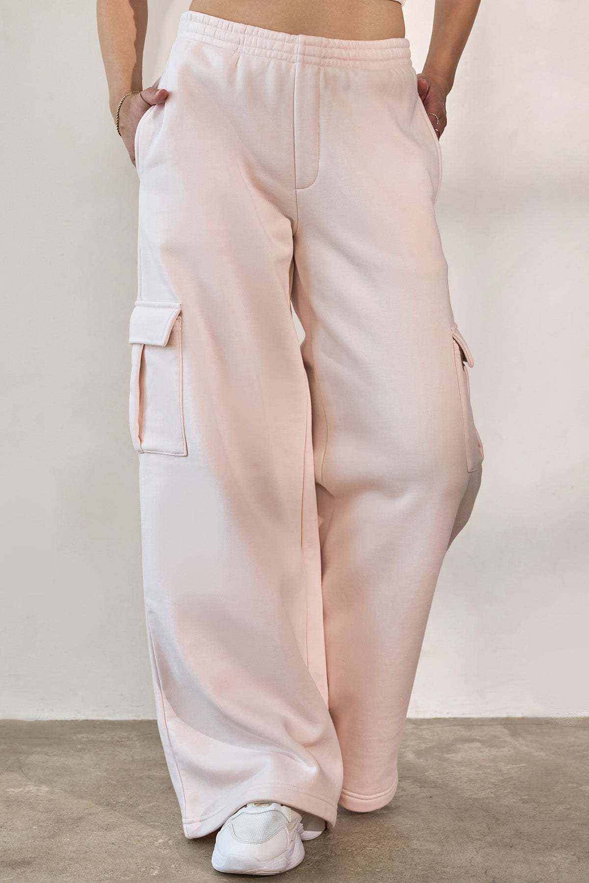 Light pink wide-leg cargo pants with drawstring waist and side cargo pockets