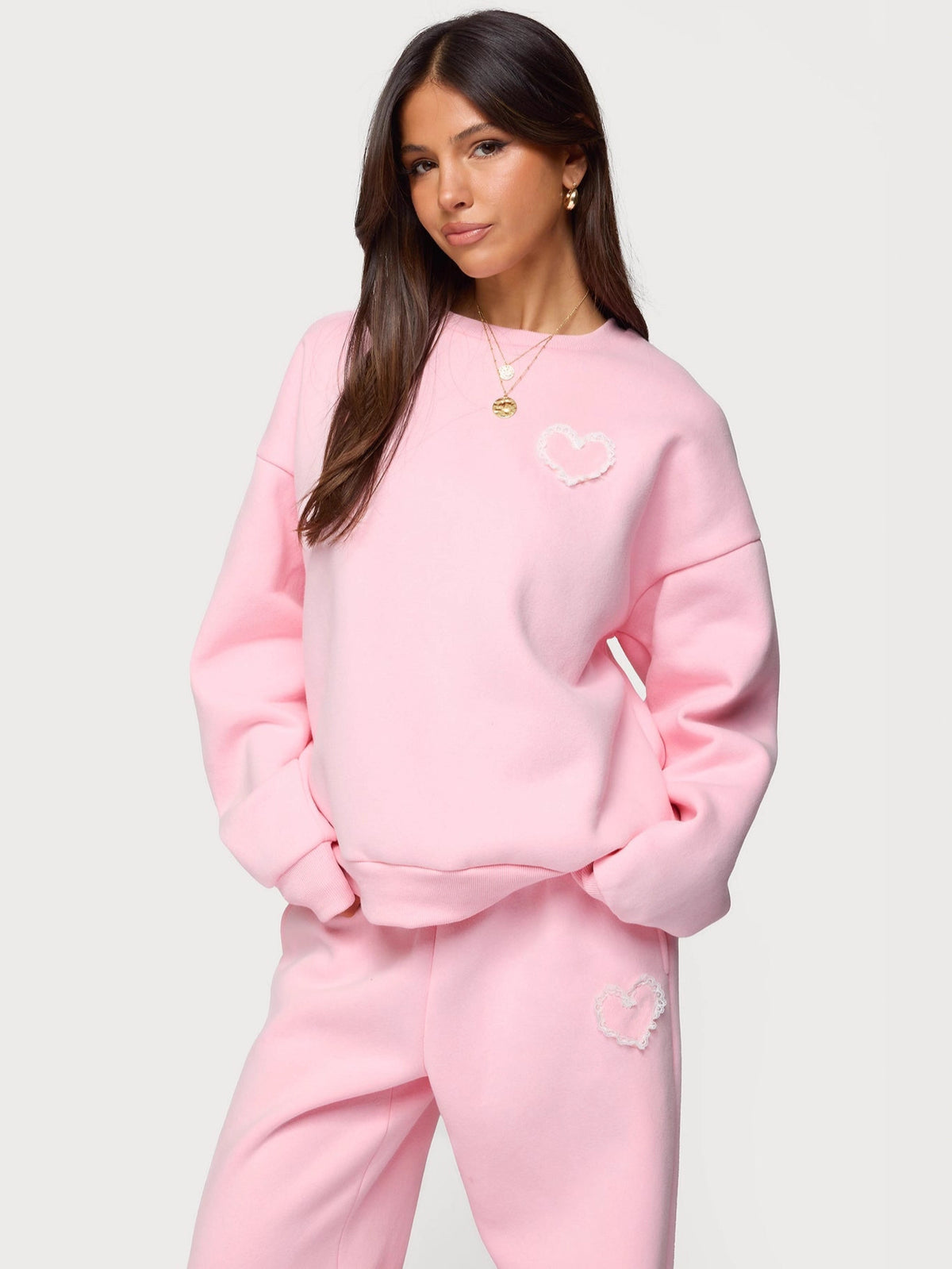 Pink heart logo sweatshirt and matching sweatpants two-piece outfit