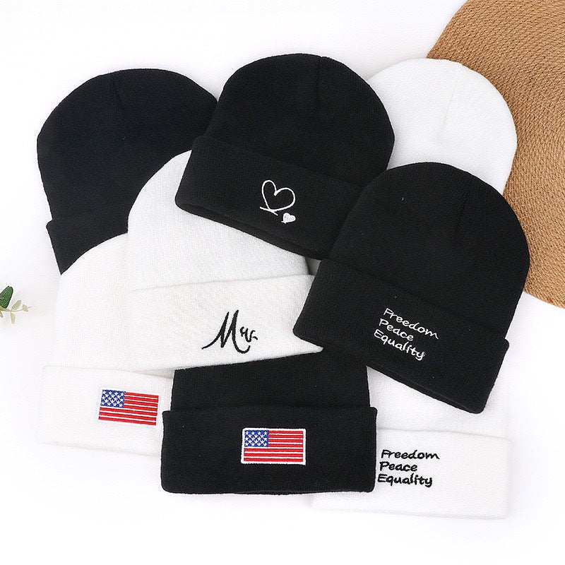 Set of knit beanie hats: black and white with Freedom Peace Equality embroidery and flags