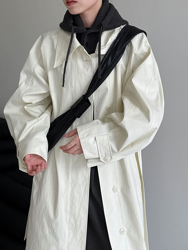 Women’s white lapel trench coat with button front and tie-waist belt