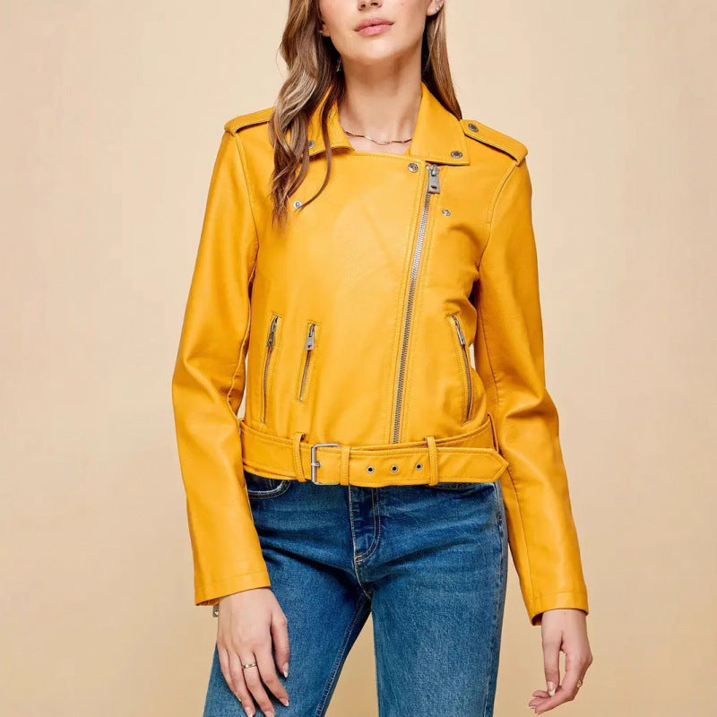 Women's short PU leather jacket in mustard yellow, zip-front with belt and zipper pockets