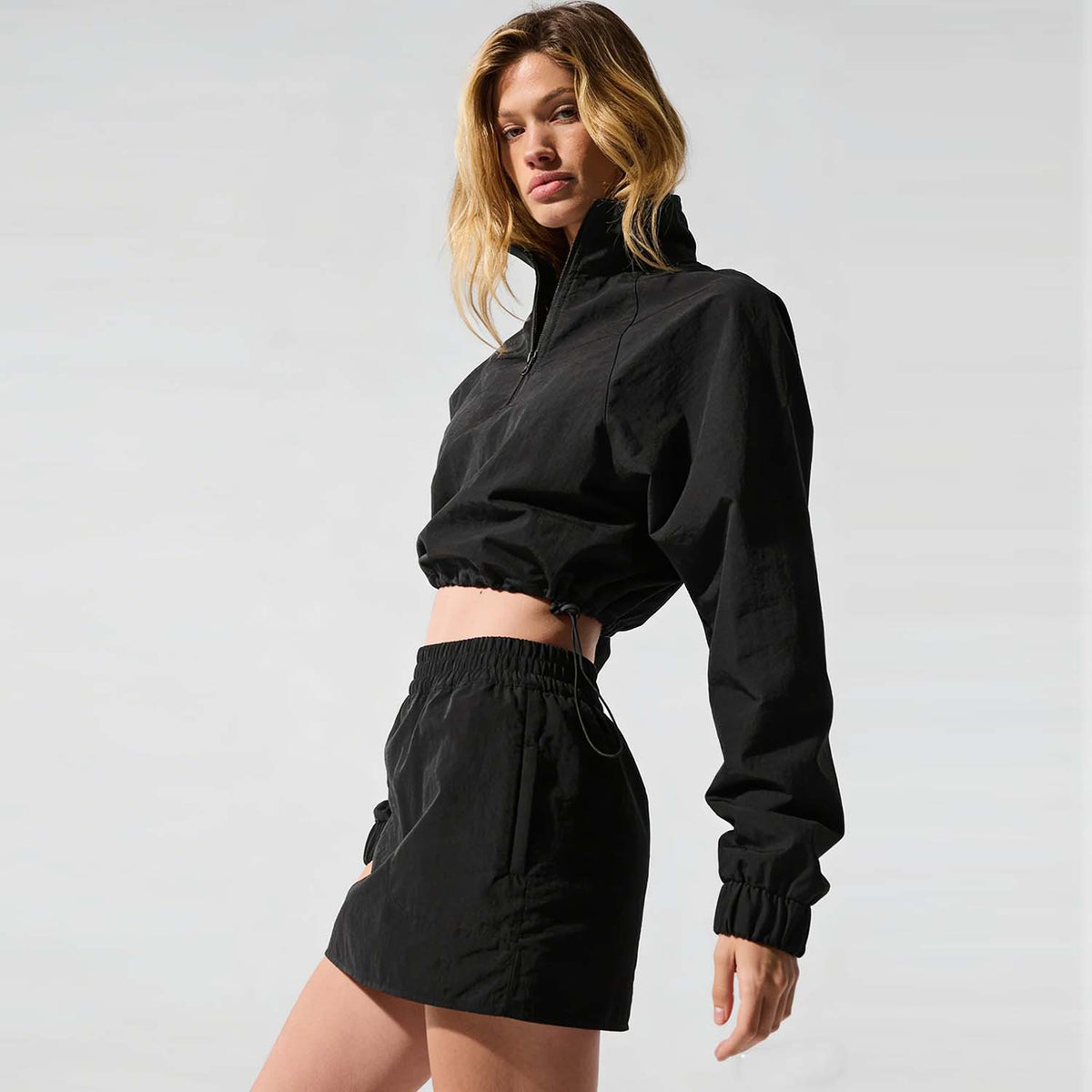 Women’s black pullover jacket and mini skirt set with elastic waistband