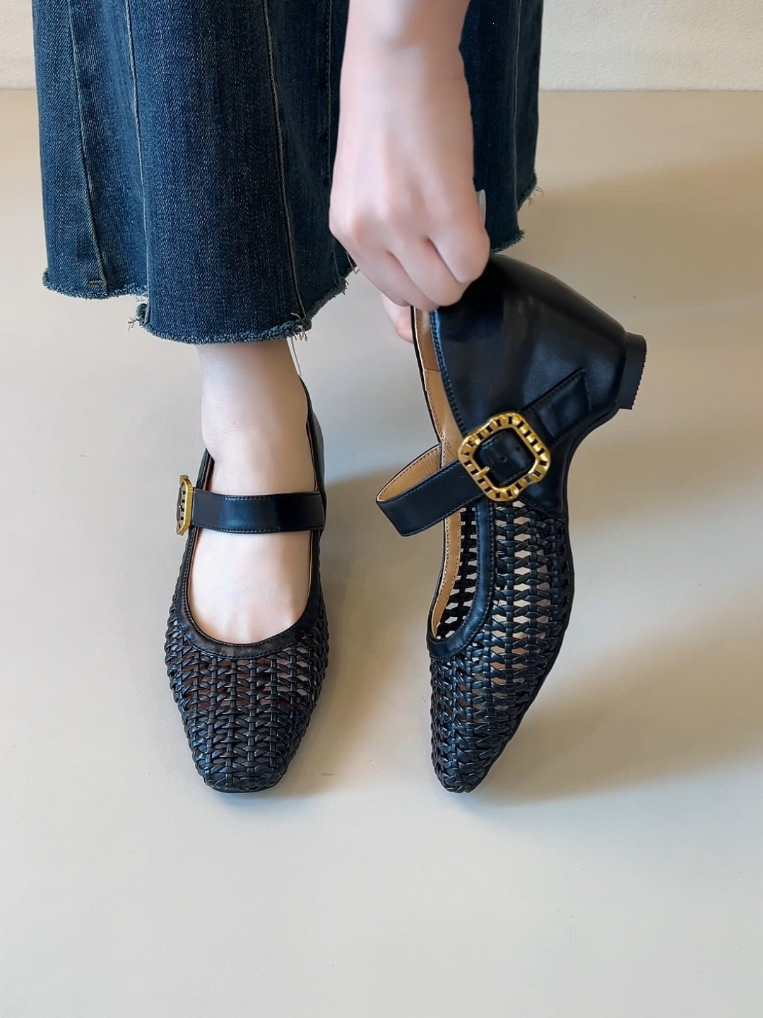 Black woven Mary Jane heels with single strap and square toe, gold buckle