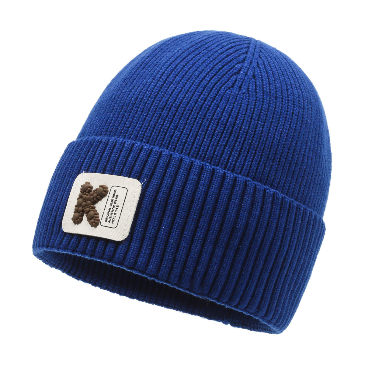 Blue rib-knit beanie with pom-pom style patch on front cuff