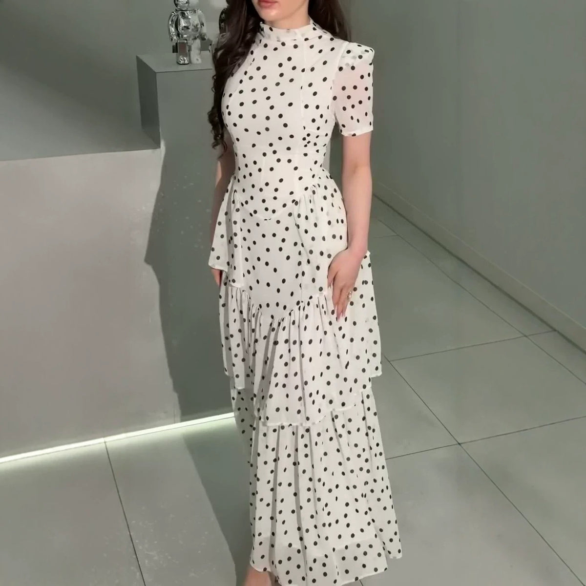 White polka dot maxi dress with high neck, puff sleeves, tiered ruffle hem