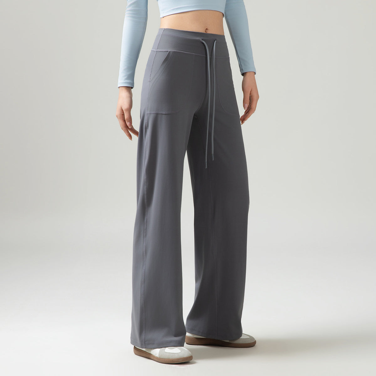 Women’s high-waisted wide-leg pants with drape, gray, side drawstring ties and pockets.