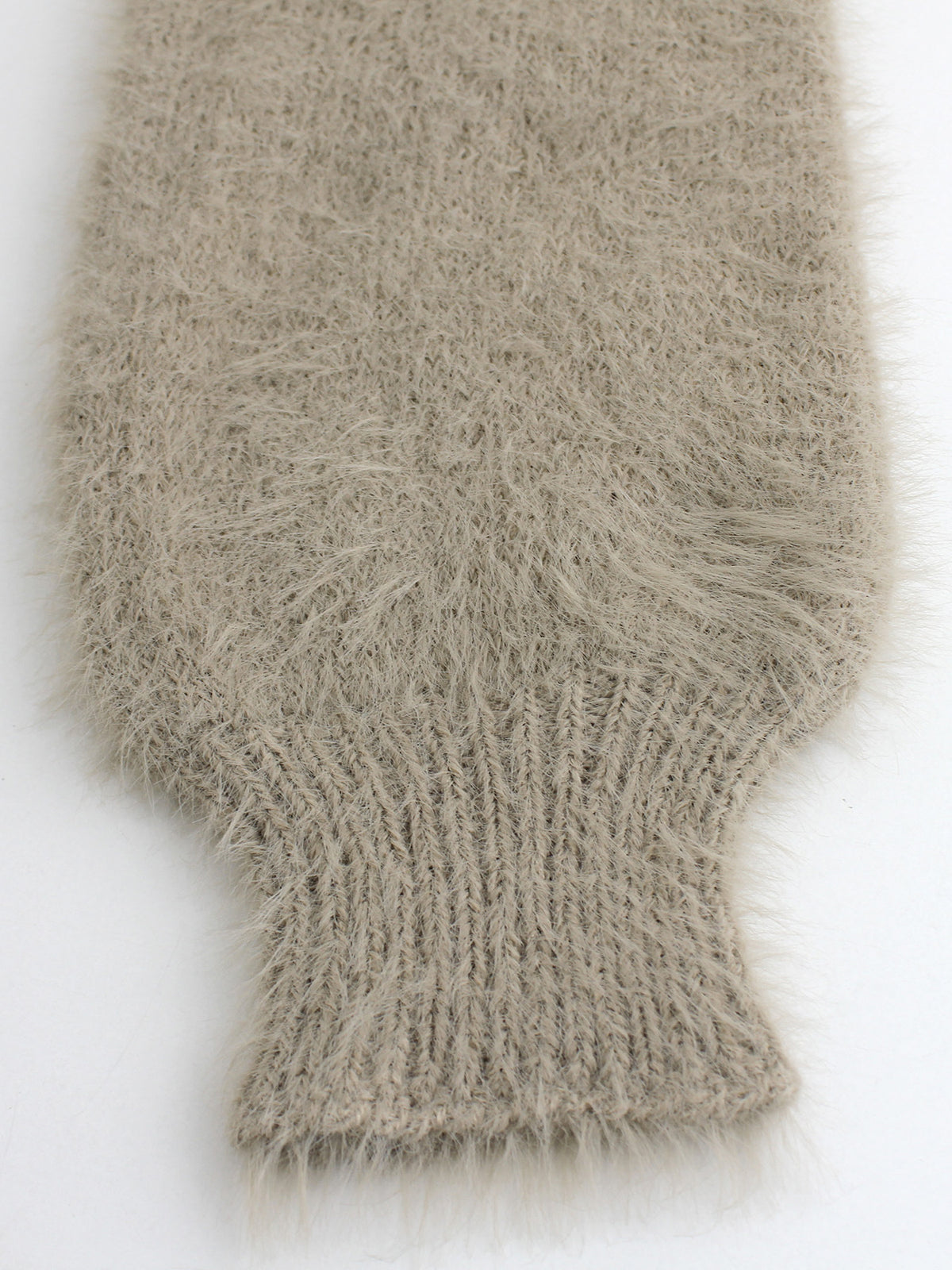 Close-up of fuzzy knit cardigan hem and cuff edge