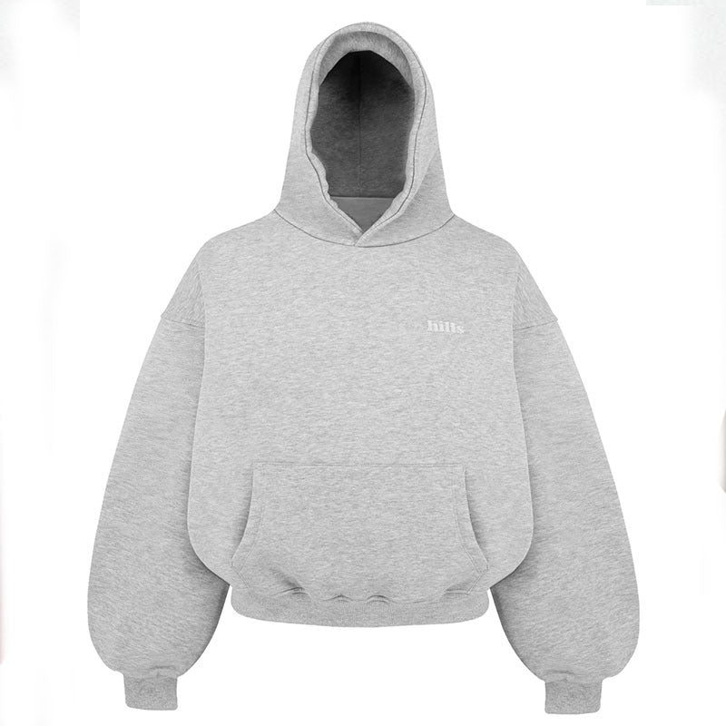 Loose hooded pullover sweatshirt in light gray with front kangaroo pocket and chest text