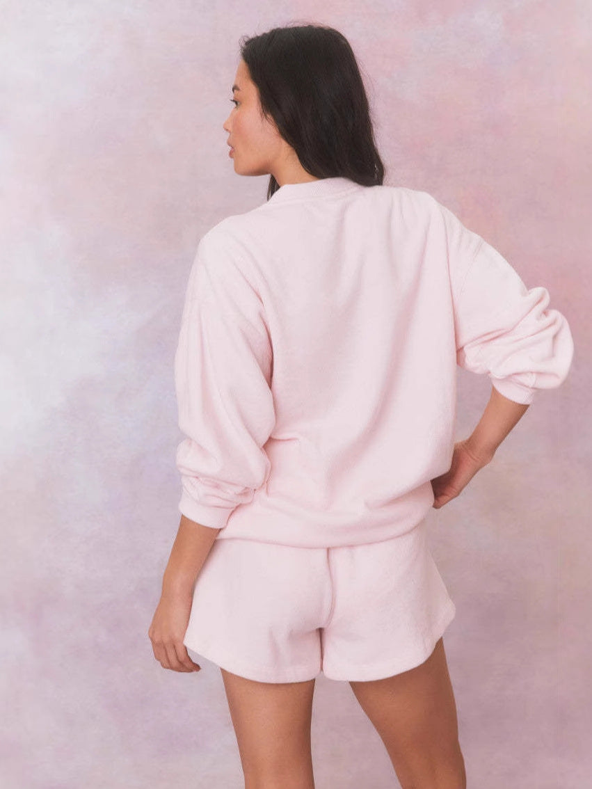 Pink crewneck velvet sweatshirt with long sleeves, back view