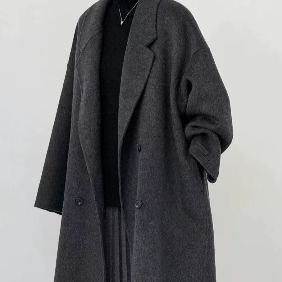 Gray long wool coat close-up with notched lapels and buttoned double-breasted front