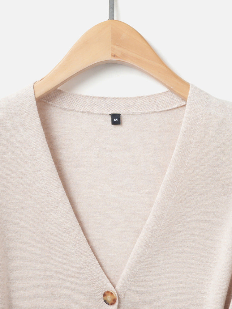 Women’s V-neck knit cardigan neckline with button placket and wood-tone button.