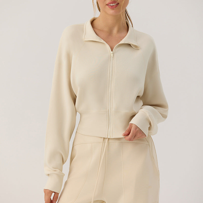 Beige stand-up collar zip cardigan with long lantern sleeves and relaxed fit, close-up front.