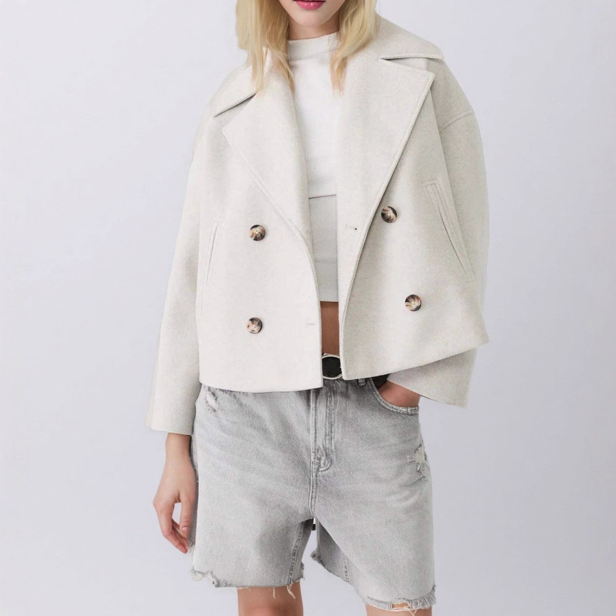 Cream double-breasted short wool jacket with notched lapels and silver button details