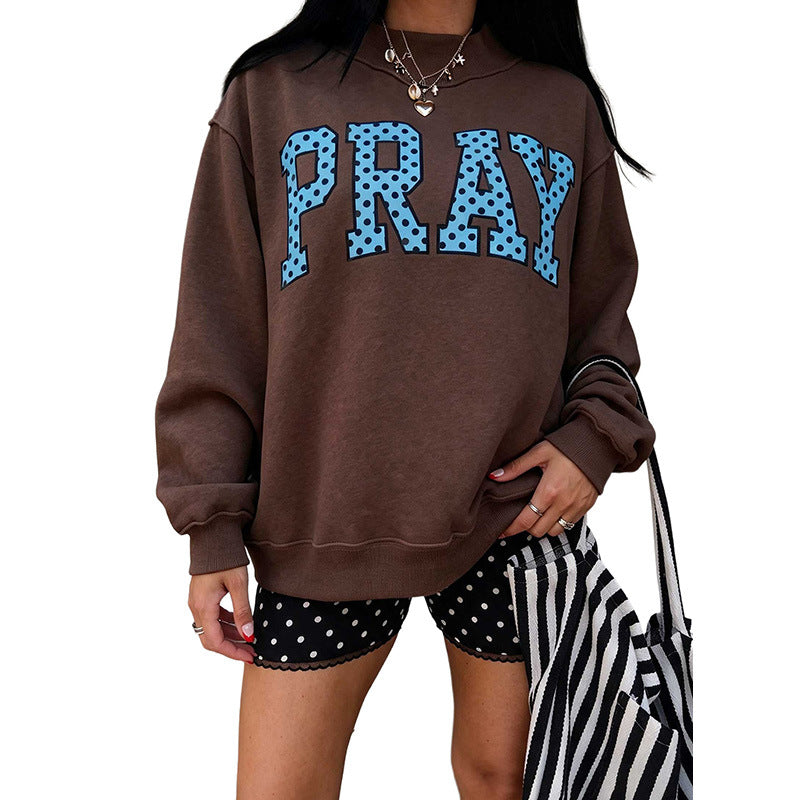 Women's brown raglan sweatshirt with 'PRAY' polka-dot letter graphic