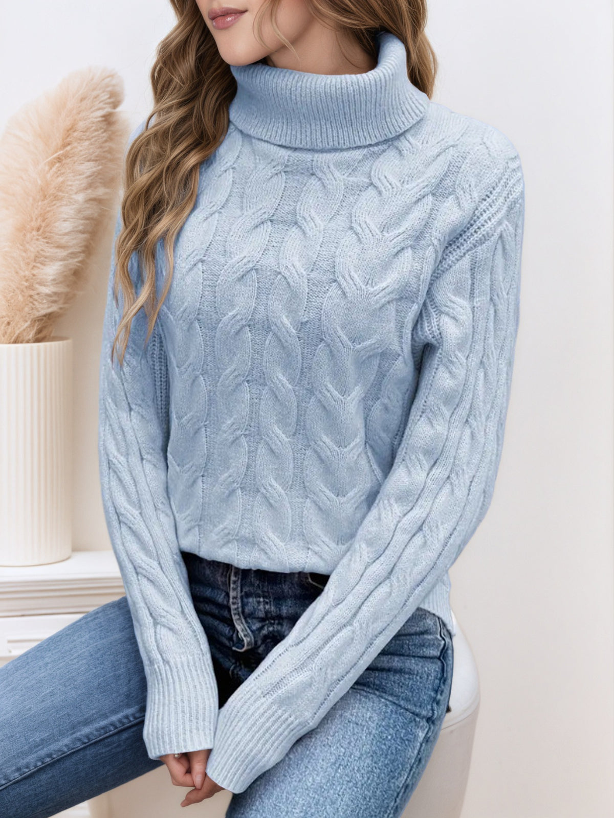 Light blue knit turtleneck sweater with long sleeves and cable twist texture