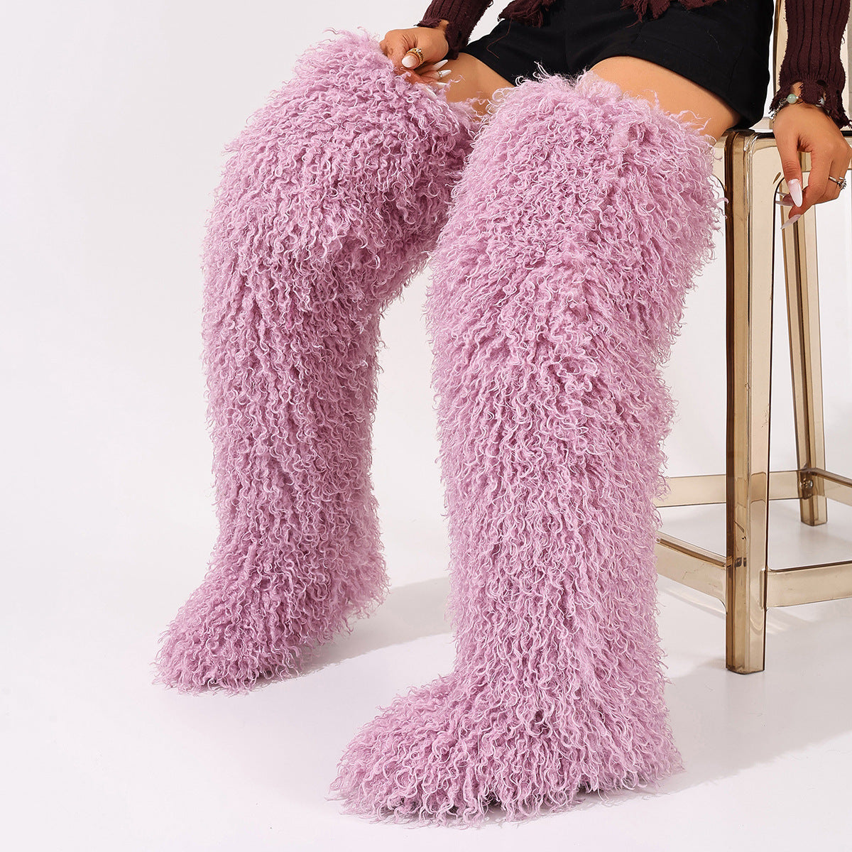 Pink faux fur thigh-high boots with curly pile