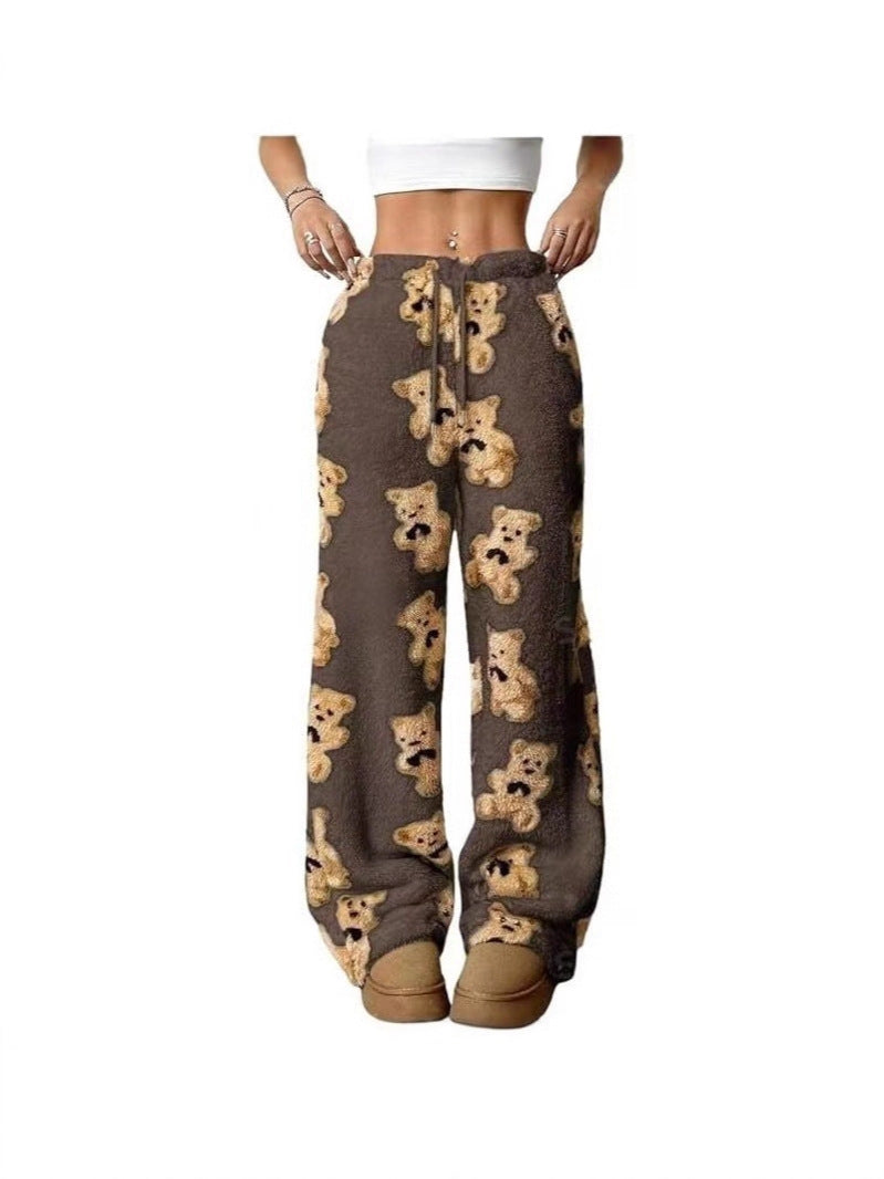Loose fleece pants with dark base and teddy bear print, drawstring waist
