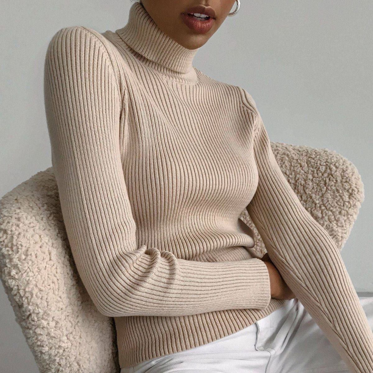Beige ribbed turtleneck knit sweater with long sleeves and fitted waist
