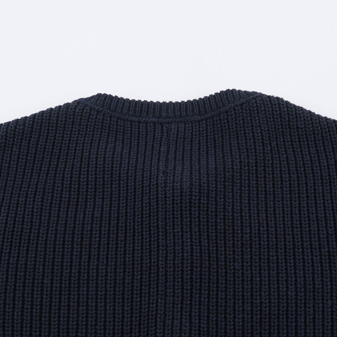 Dark blue chunky knit cardigan back yoke with dense ribbed knit texture