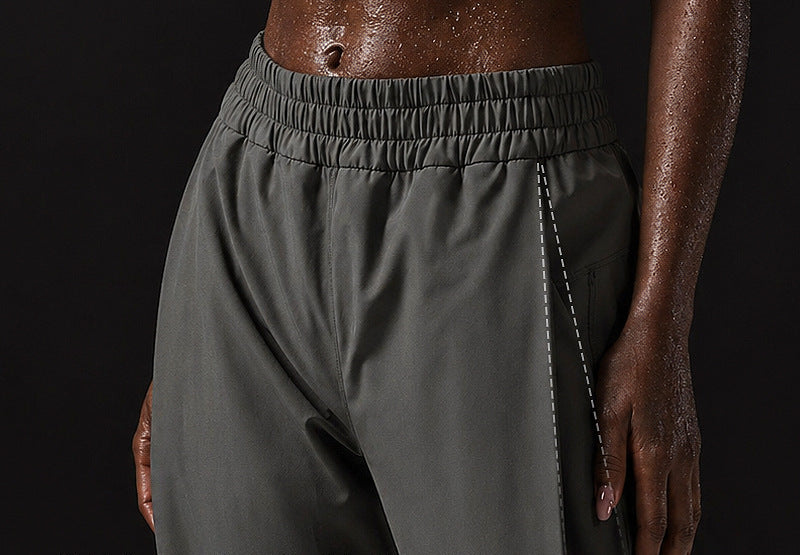 Women’s wide-leg sweatpants with elastic waistband, dark gray fabric, side seam detail.