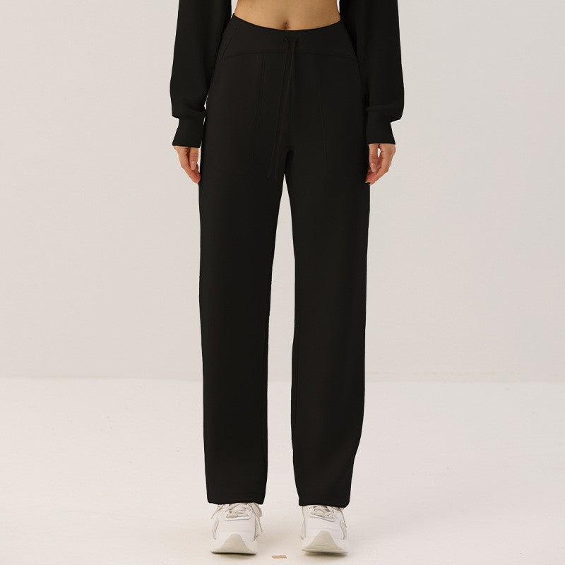 Black cropped zip cardigan with stand-up collar and loose lantern sleeves, lower-body view.