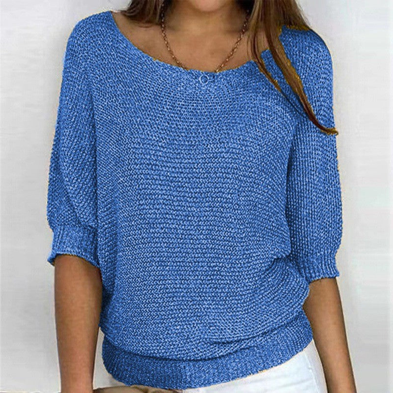 Blue knit top with round neck and three-quarter sleeves, textured knit with ribbed trim