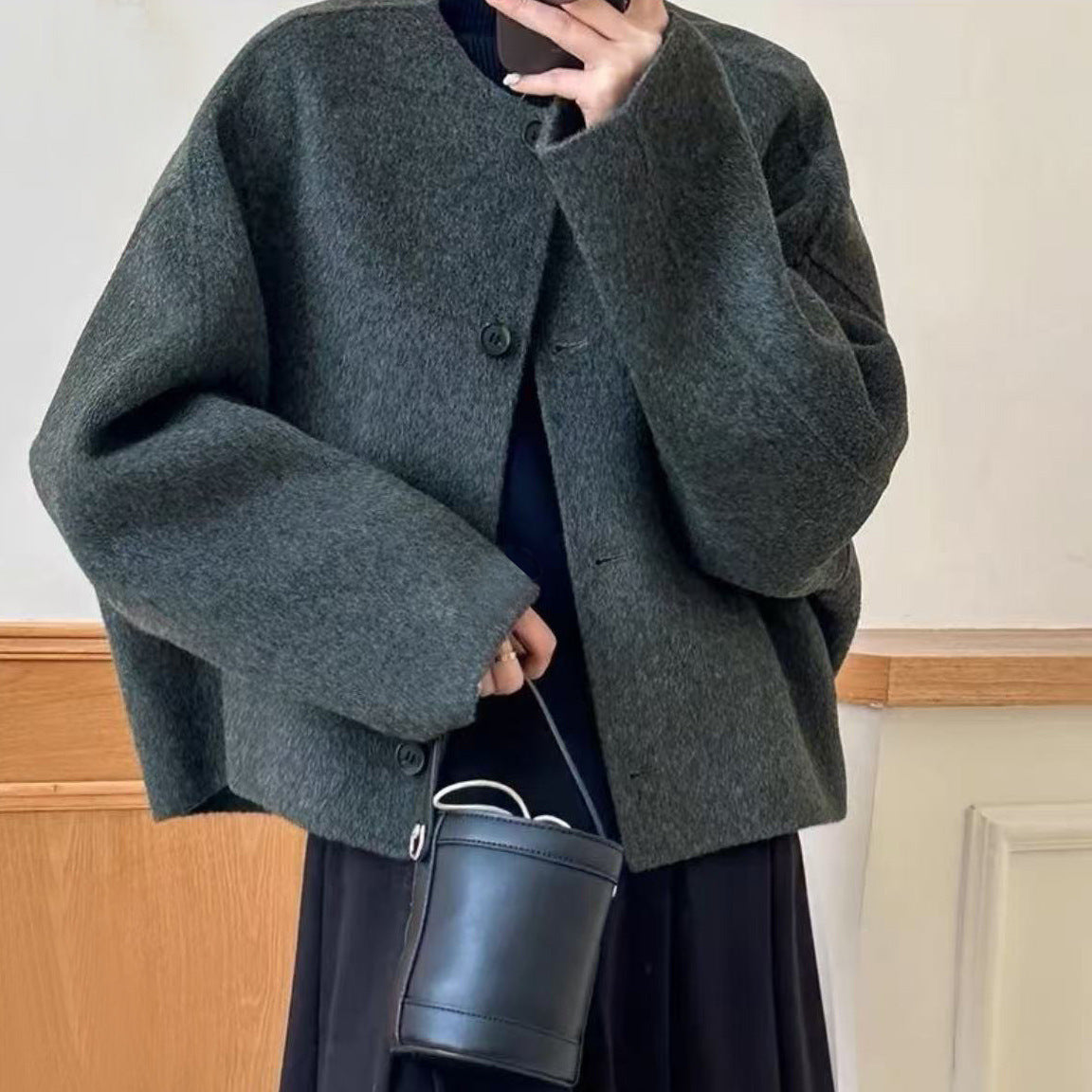 Women’s dark green boiled wool jacket with button front and stand collarless neckline