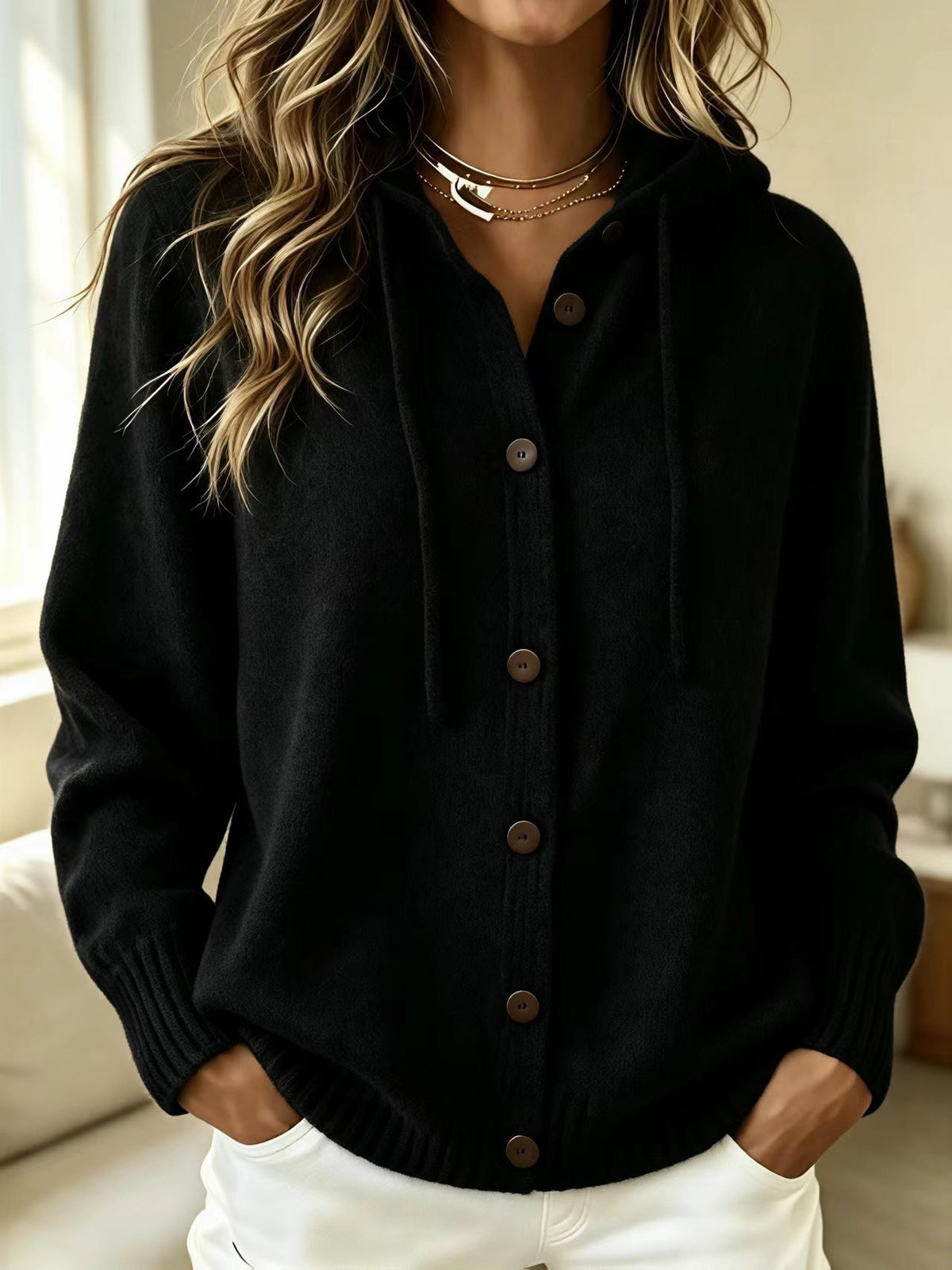 Black hooded knit cardigan sweater with front button placket and drawstring hood
