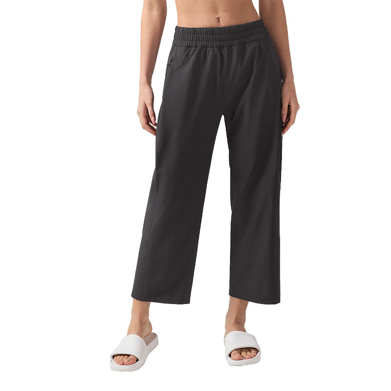 Women’s wide-leg sweatpants with elastic waistband, black fabric, cropped straight fit.