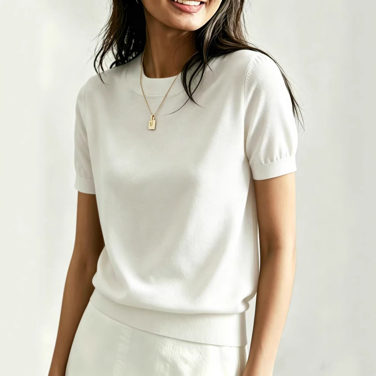 Women's white round-neck t-shirt with short puff sleeves and ribbed hem