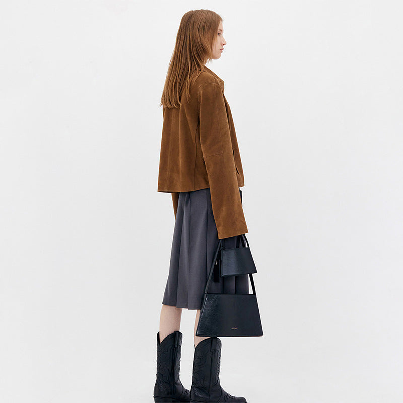 Side view of the brown cropped suede jacket with long sleeves.