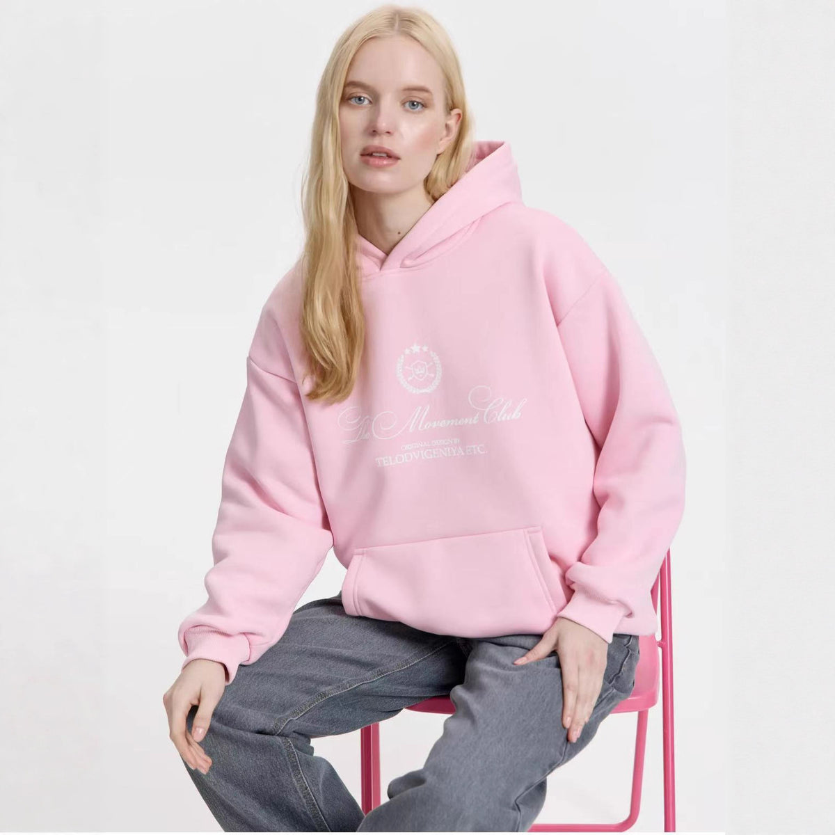 Pink velvet hooded sweatshirt with chest graphic and front kangaroo pocket