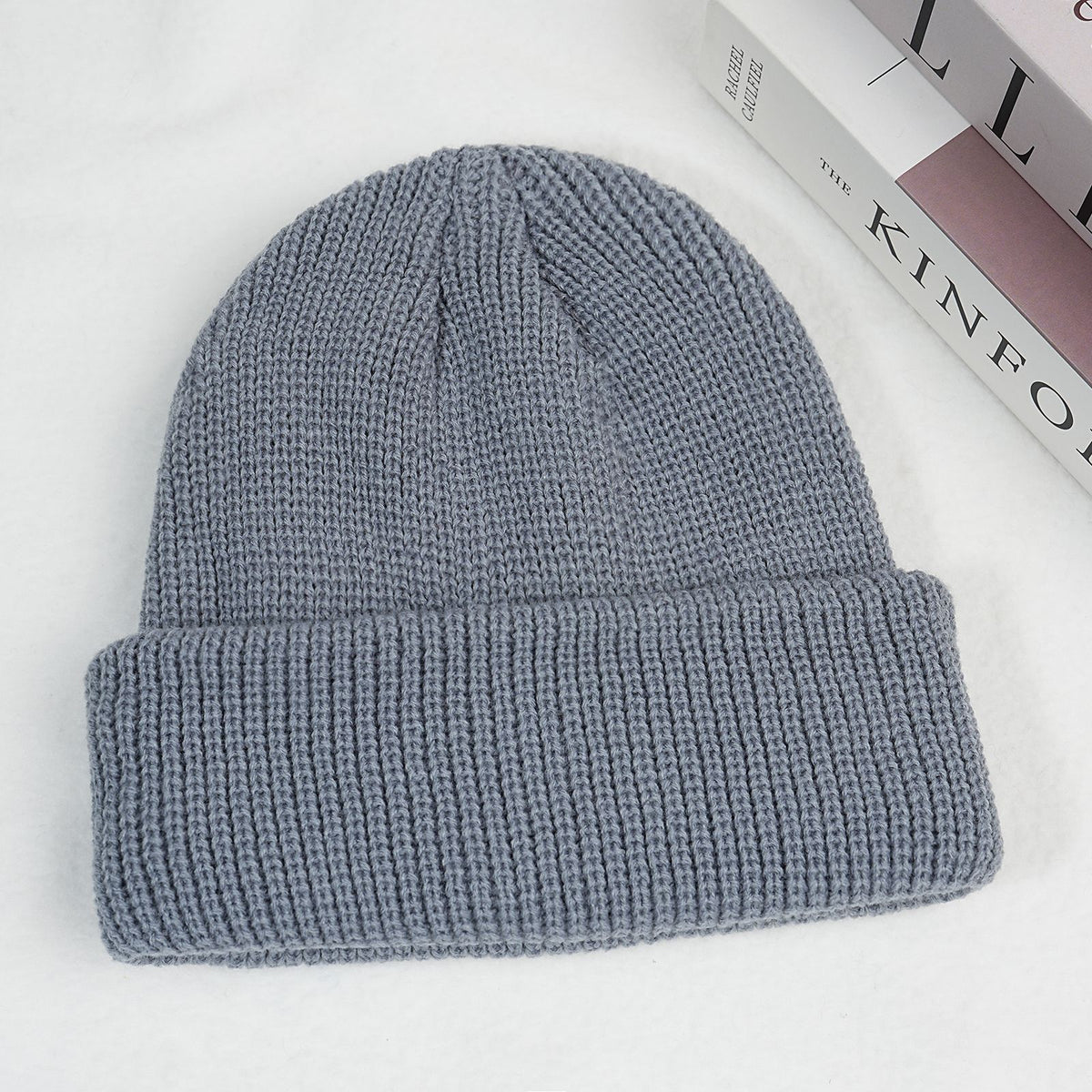 Gray-blue thick ribbed knit beanie hat with folded cuff.