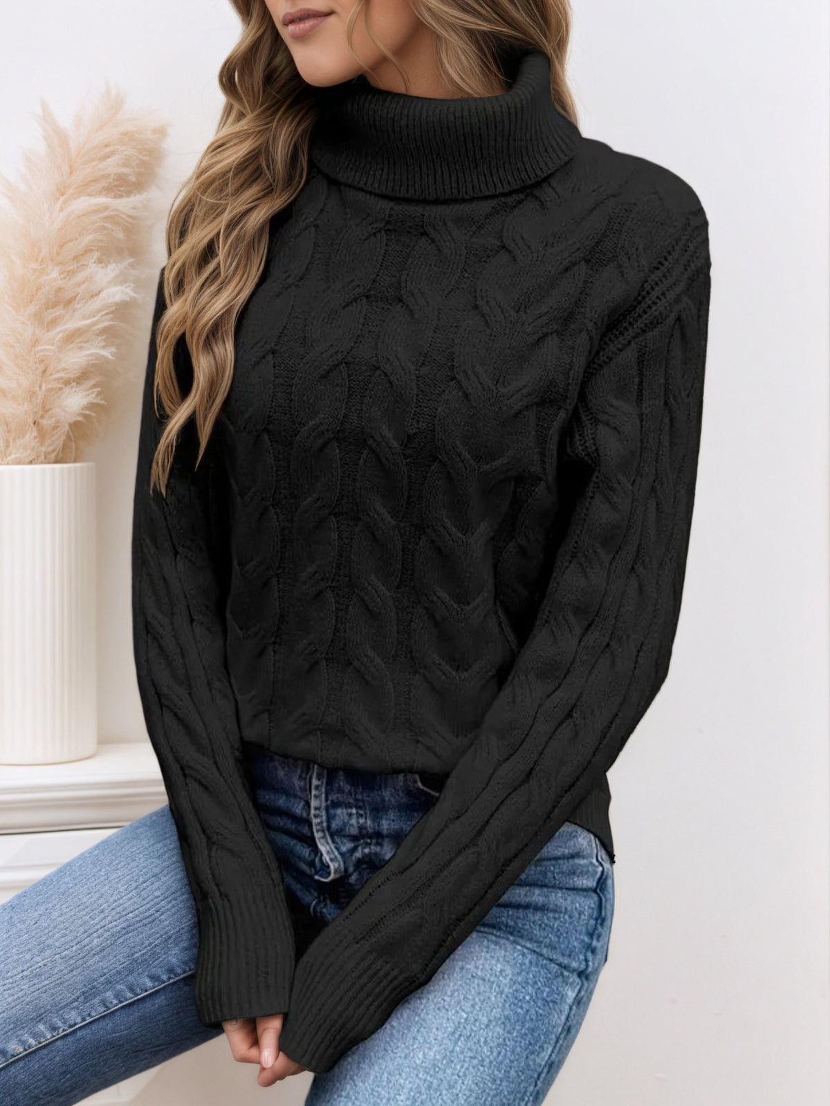 Black knit turtleneck sweater with long sleeves and cable twist texture