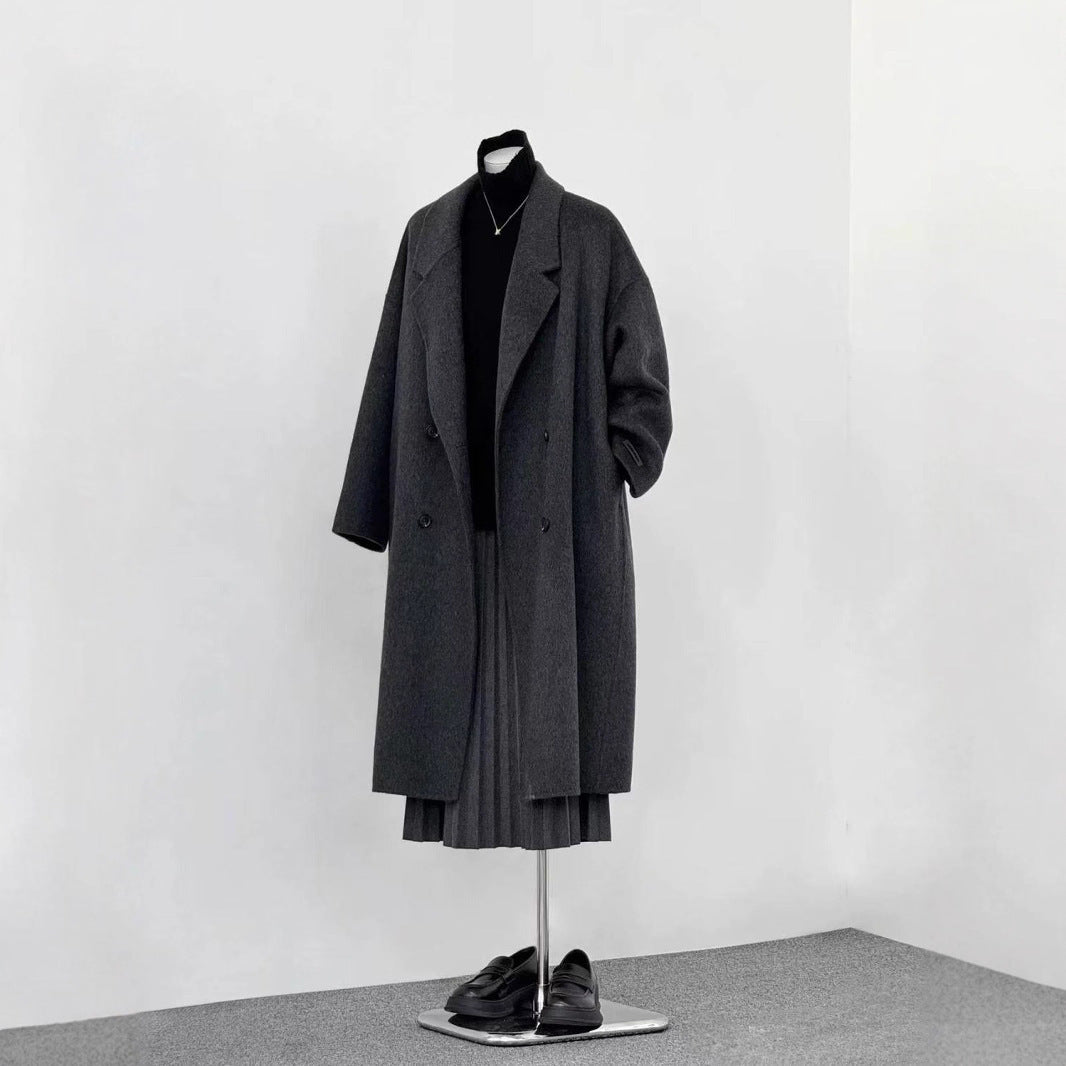 Black long wool coat with notched lapels, double-breasted buttons, and 3/4 sleeves