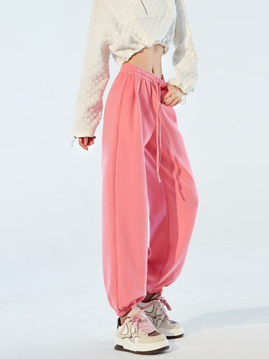 Pink high-waist harem joggers with drawstring and gathered elastic cuffs.