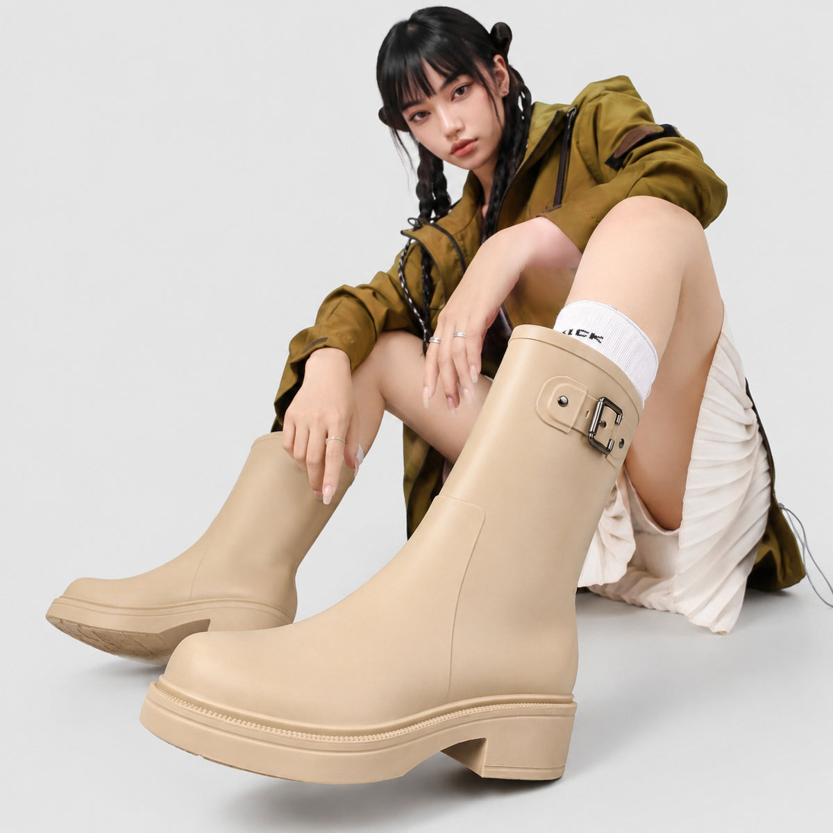 Women's beige mid-calf rain boots with buckle strap and thick outsole