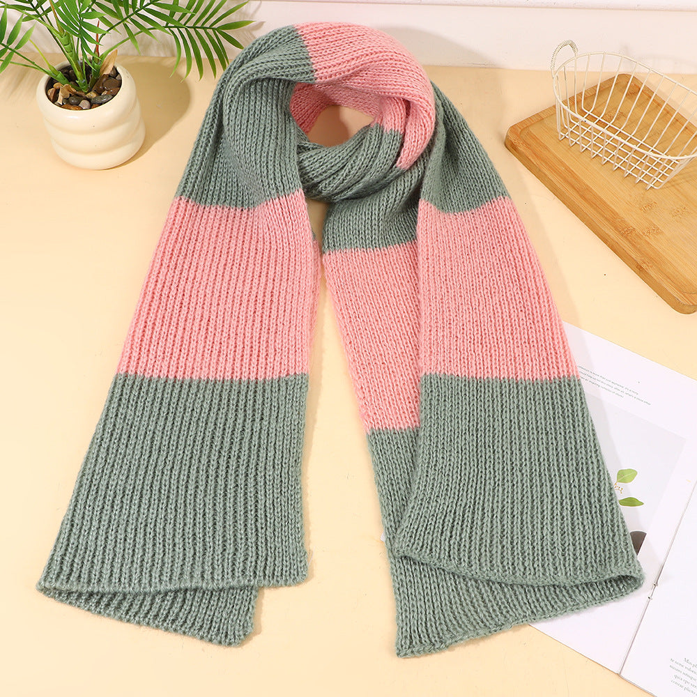 Green knit scarf with wide pink stripe, folded and ribbed