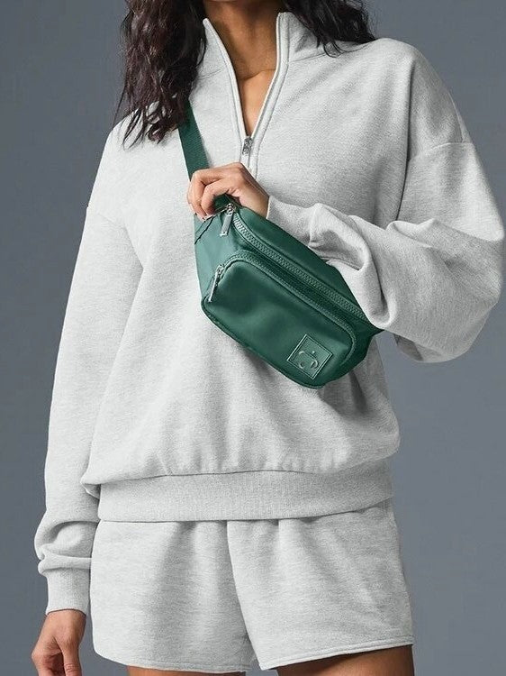 Gray half-zip pullover sweatshirt with stand collar, long sleeves, front zip detail