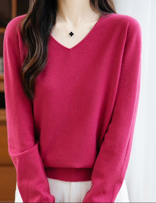 Women's V-neck cashmere sweater in fuchsia pink, long sleeves, ribbed hem.