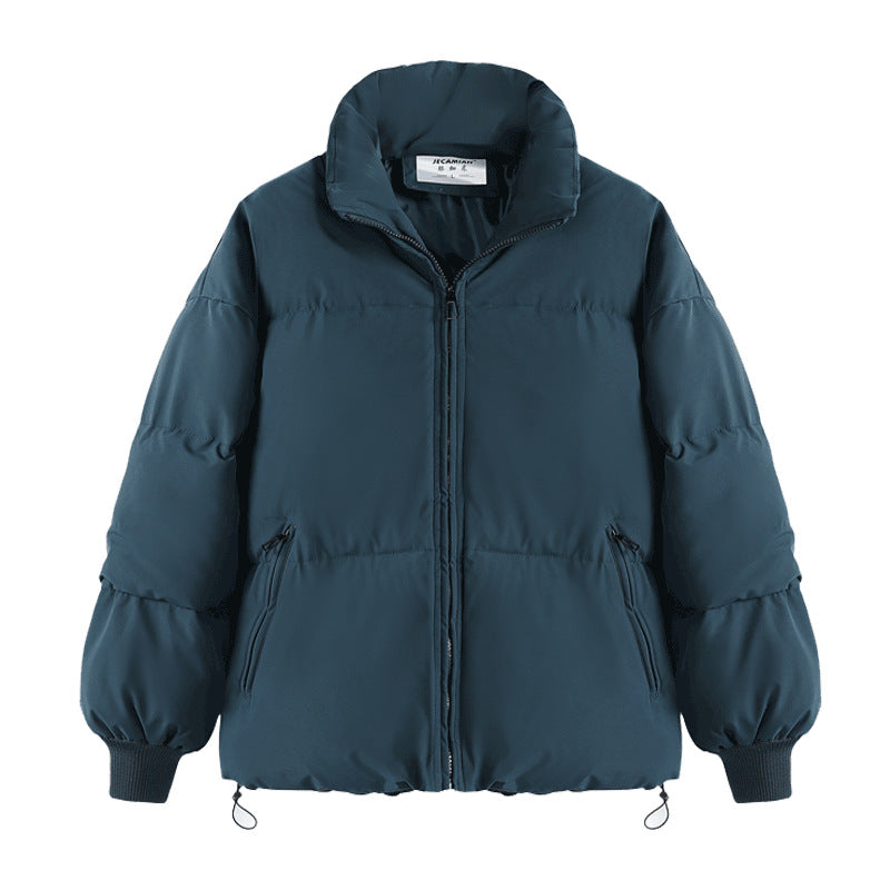 Short teal puffer jacket with full zip front, stand collar, and ribbed cuffs