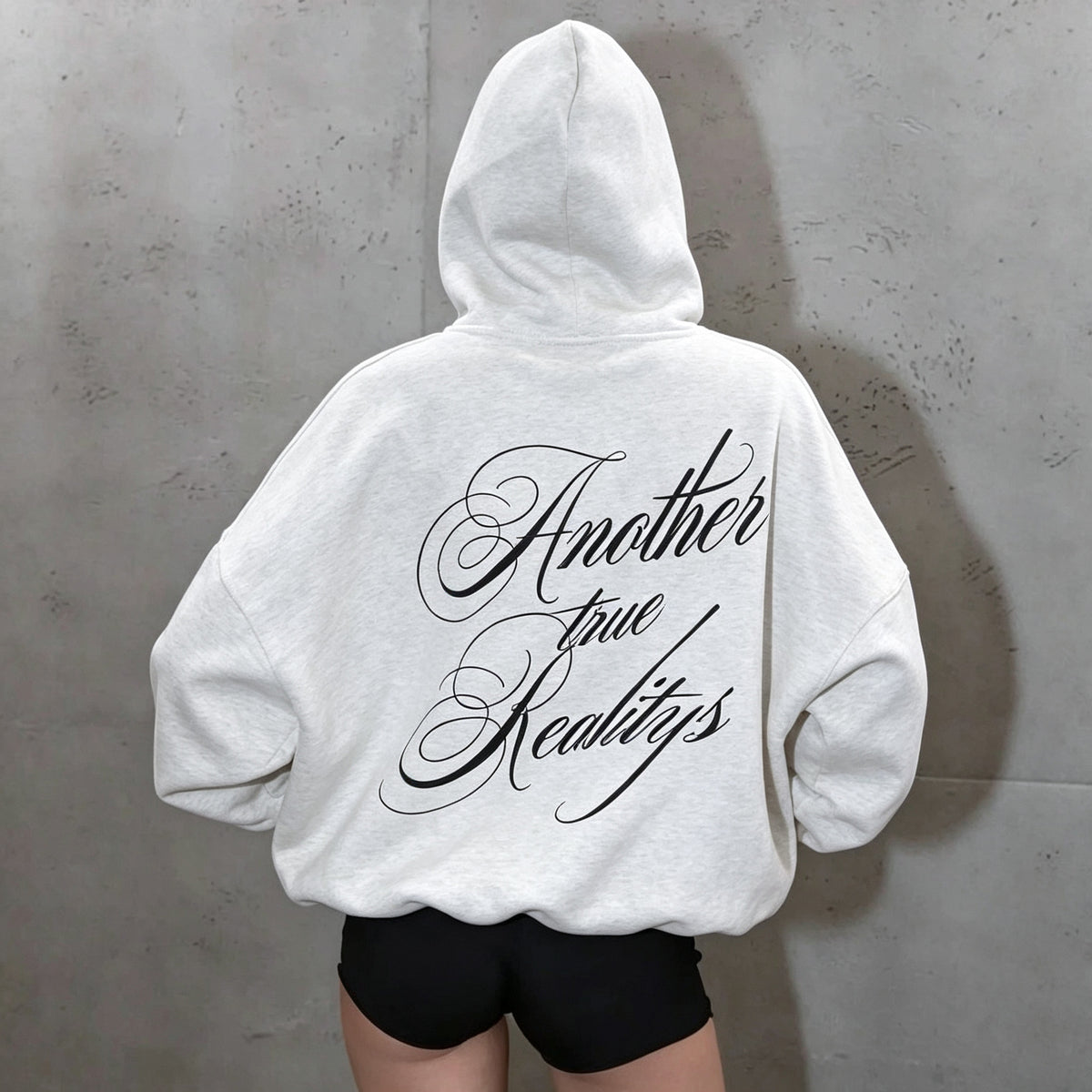 Light gray hooded women's sweatshirt with oversized black script on the back