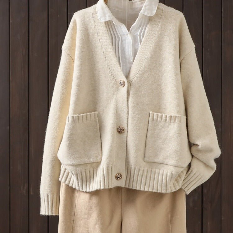 Off-white wool cardigan with V-neck, button front, ribbed cuffs, and patch pockets