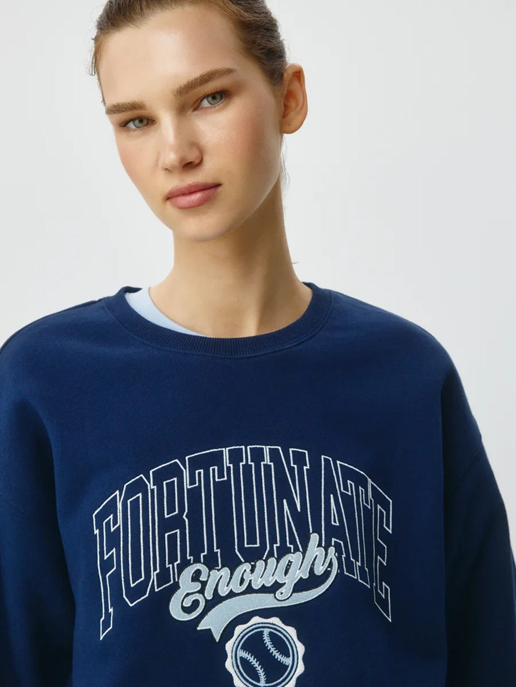 Dark blue crewneck sweatshirt with large front logo graphic