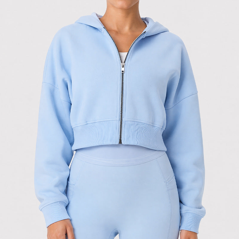 Light blue zip-up hooded cropped sports jacket with long sleeves and front pockets